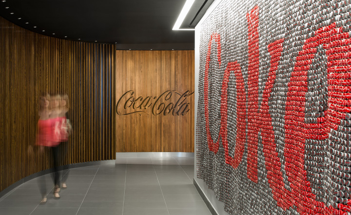 An elevator lobby featuring a tapestry made of 16,000 red and silver bottle caps by local Toronto artist, Raymond Waters. Photo by Steve Tsai Photography.