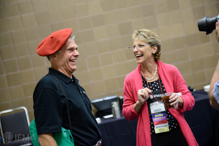 Kate Lister approves of another WE member's signature Workplace Evolutionaries beret. Photo courtesy of IFMA.