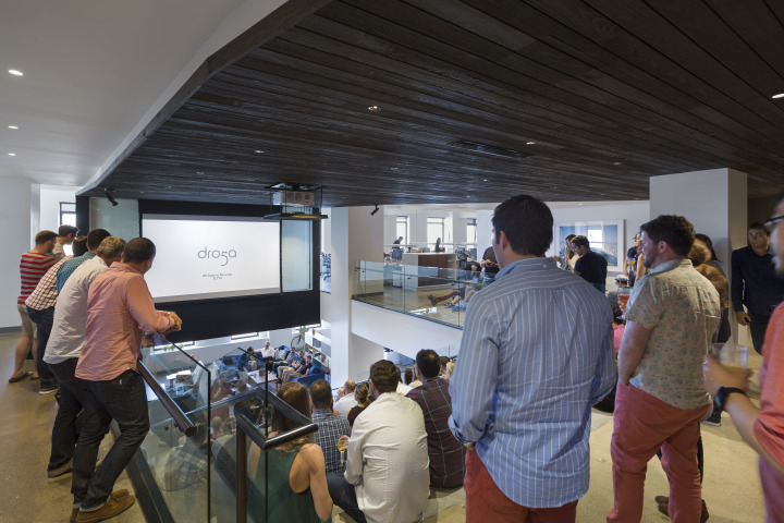 In addition to appealing to most everyone's yen for rustic, authentic textures, charred wood siding, seen here above the stairs, marks the primary path that connects spaces in the office. Here, employees gather on the stair for a meeting.