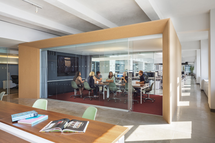 This glass enclosed conference room sits within the open office area, and—we love this—it's clad in cork for spur of the moments pin ups and reviews.