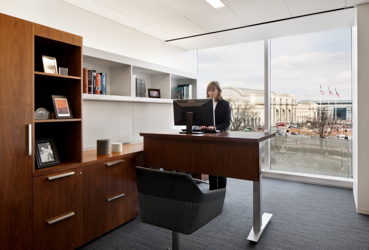 An employee works from her standing desk at the D.C. office of law firm McDermott Will & Emery. Photo by Michael Moran of Moran Photography.