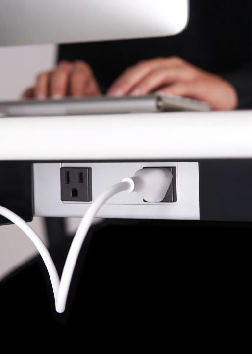 Power cable cutouts on the M1 offer cord management designed to keep the desk surface clean and clutter-free. Photo courtesy of Stir.