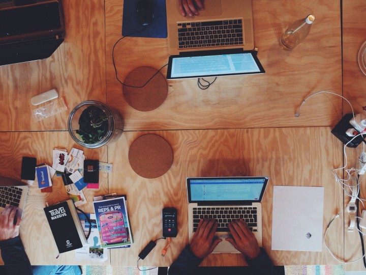 Coworkers coworking at Surf Office in Santa Cruz, a beach villa/coworking hybrid. Photo via thesurfoffice.com