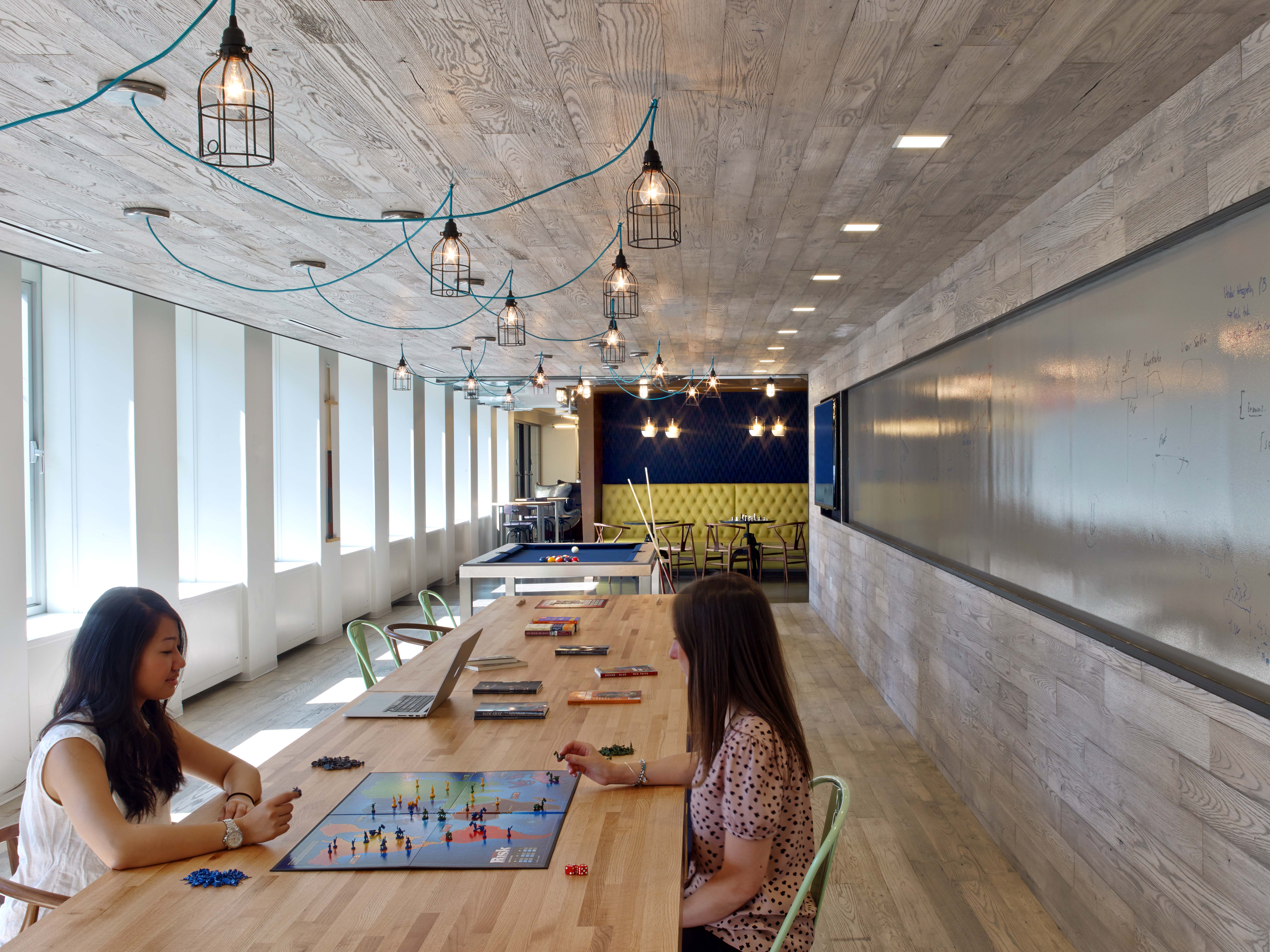 The functional game area, that includes a TV and chalkboard for ideating, in addition to “playing”. Photo by Eric Laignel Photography.