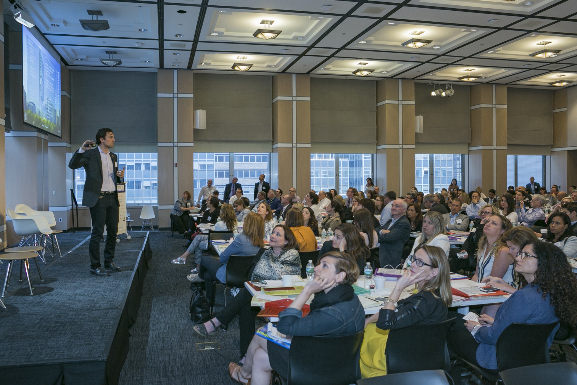 Chris Kelly, founder of Convene — the host venue — speaks to the sold out crowd about the future of real estate as a service. Photo by Robert Manella.