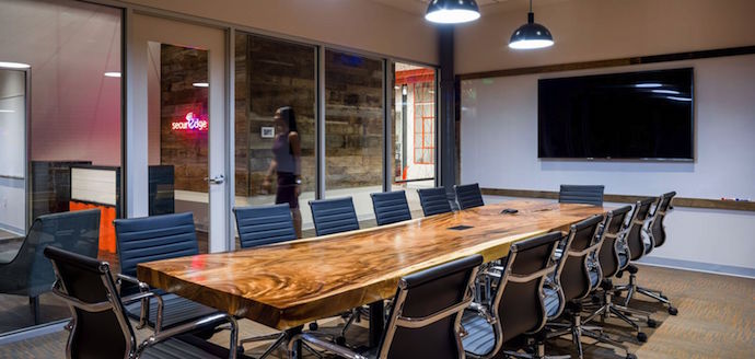 SecurEdge's conference room contains a wooden slab table made from recovered lumber. Image courtesy of Peter Bretlinger.