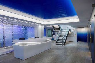 The new workplace design includes several custom-designed pieces, such as this wave-like reception desk. Image courtesy of
