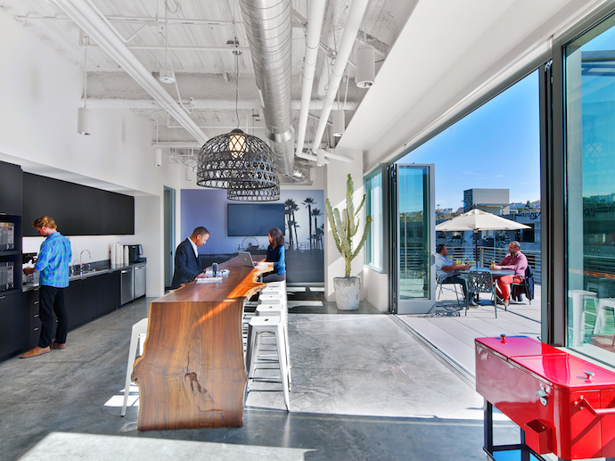 The pantry of this space features a moveable glass wall and raw edge table. Image courtesy of Eric Laignel.