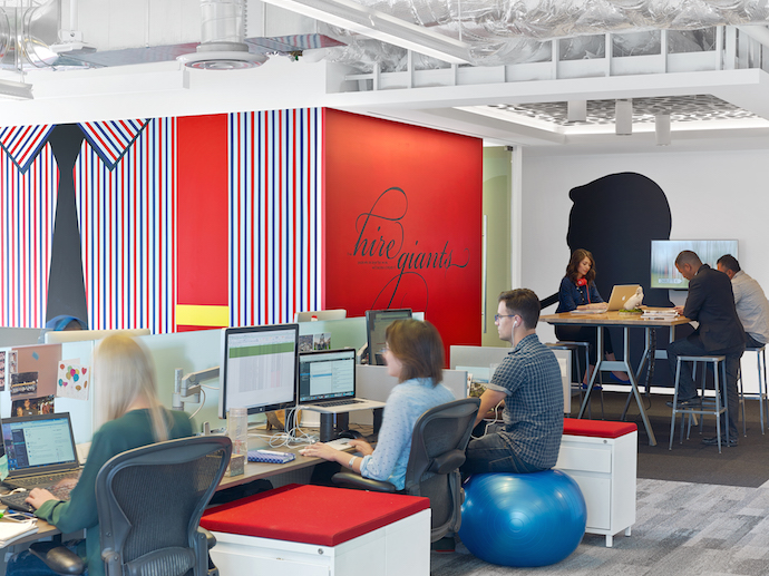 The open office features branding and collaboration areas. Image courtesy of Eric Laignel. 