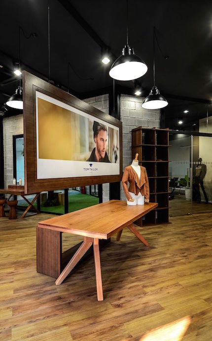  Product display, large poster and warm lightings create fashion boutique environment along with wooden floor featuring out-door materials; align with Fashion Park concept. Image courtesy of Thuc Le Photography.