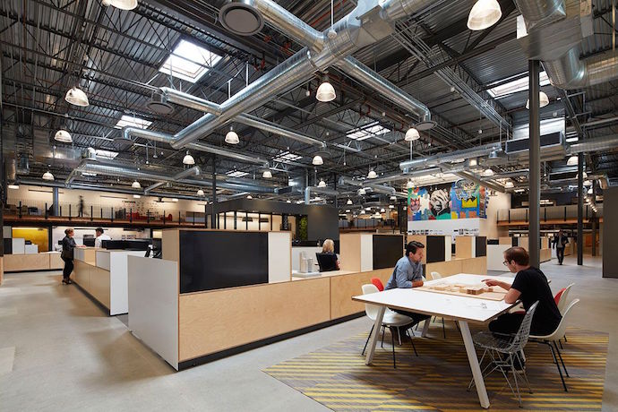 Custom tables and workstations, with Basquiat-inspired mural in the background. Image courtesy of Fotoworks, Benny Chan Photography.