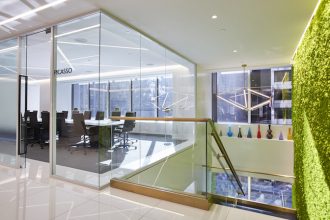 A glimpse at Emerge212’s two-story, floor to ceiling moss wall and Picasso conference room, which nods to the artist with details like a cubism-inspired rug. Image courtesy of Emerge212.
