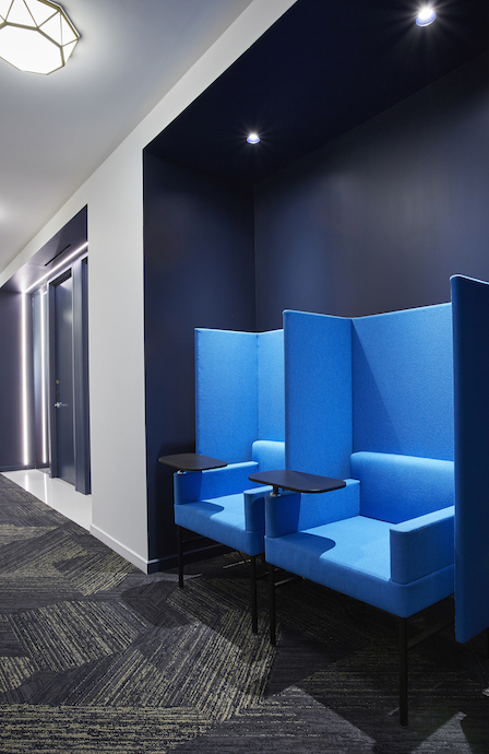 Emerge212 hallways offer nooks for private phone calls and feature the best of hotel design elements, including LED lighted door portals, large “room numbers,” and keyless entry. Image courtesy of Emerge212. 
