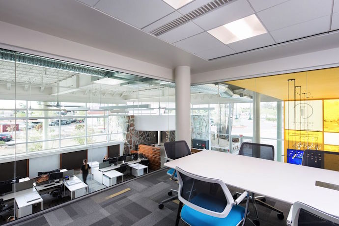 A dramatic glass-enclosed space is used for client meetings. Image courtesy of Cuningham Group Architecture.