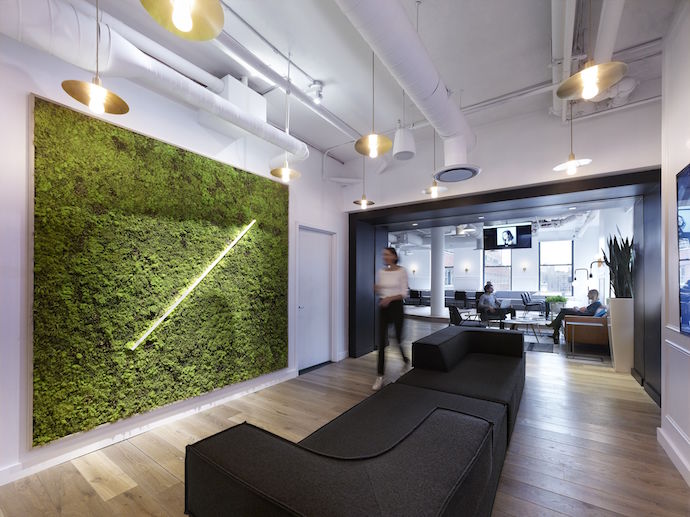 The strategic use of angles, which reflect the Compass tick mark brand element, was carried through lighting, floor materials, custom wallcovering and other design elements. Image courtesy of Matthew Carbone.