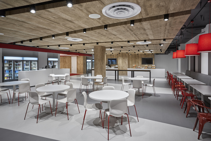 A big café provides a space for constant daily use, not only for meals, but for small meetings, large presentations and townhalls. Image courtesy of Garrett Rowland. 